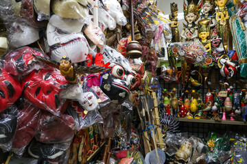 Various types of handmade souvenirs for sale at Sukawati Art Market in Gianyar, Bali. From intricate wood carvings, wooden masks, and colorful paintings to beautiful textiles and unique jewelry