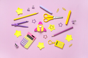 Rocket made of plasticine with stationery on lilac background. Top view