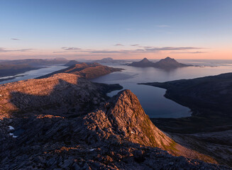 Panoramic view over the island of Tomma, helgeland, Norway in the midnight sun. Seen from over Smaltind, Breitind and Tortenviktind. Nighttime summer Norwegian hiking, fjelltur. Dusk and dawn, arctic