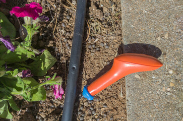 Hole puncher close to drilled irrigation pip