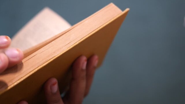 Close up of women hand turning a pager of a diary 