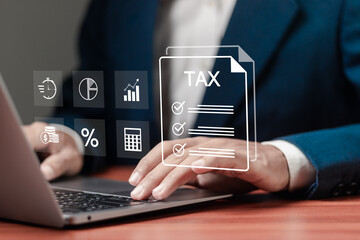 E-tax, Taxpayer using laptop filling out tax forms online for tax payment. State taxes, data...