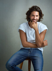 Casual, fashion and portrait of happy man on chair with confidence, designer clothes or relax in...