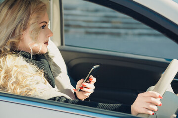 Distracted businesswoman texting on phone while driving car