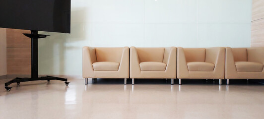 brown leather chairs is placed in the corner of the reception room