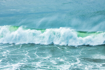 Wave splashing close-up. Crystal clear sea water, in the ocean in San Francisco Bay, blue water, pastel colors.