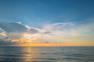 Sunset on sea. Beach sunrise with cloudy sky.
