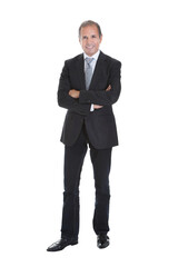 Confident Senior Businessman Standing with Arms Crossed in Elegant Suit
