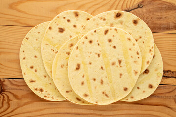 Several tasty tacos  on a wooden table, macro, top view.