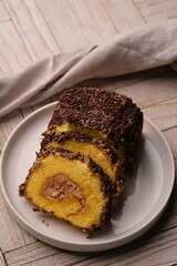 A roll cake is a sponge cake baked in a shallow pan, filled with jam or buttercream and then rolled. Roll cakes are often known as jam rolls, or jelly rolls in the United States. mocha. bolu meranti.