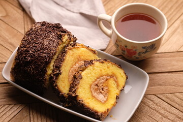 A roll cake is a sponge cake baked in a shallow pan, filled with jam or buttercream and then rolled. Roll cakes are often known as jam rolls, or jelly rolls in the United States. mocha. bolu meranti.