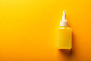 Vibrant yellow background highlights a solitary PVA glue bottle, its transparent body and white cap popping against the bright hue, with ample space for text or graphics overlay.