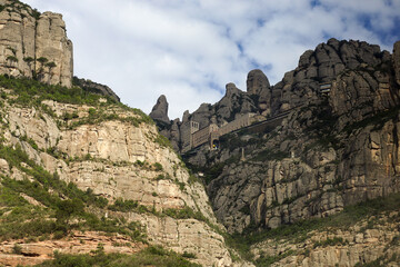 View of the Santa Maria de Montserrat Abbey (Abbey of Montserrat) nestled on the serrated mountains of Catalonia, Spain.