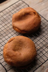 bread with coffee cream topping and butter filling. served on a cooling rack.