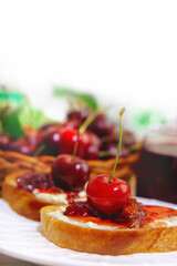 Bruschetta with cherry jam. Appetizer with ricotta cheese, cream cheese, berry jam. Toast, sweet snack for breakfast