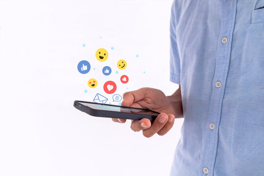 Man holding a smartphone to open social media applications. Chat with friends and send emotion icons.