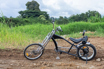 Black gangster bike on a trail in the middle of nature_Economical means of transport