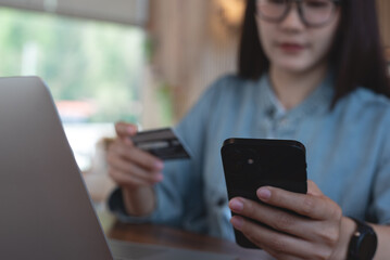 Woman using mobile phone and credit card for mobile banking, digital payment via mobile app. Female user using smartphone for online shopping and internet payment, financial technology