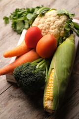 fresh vegetables. Chinese cabbage, broccoli, carrots, sweet corn, tomatoes, celery, cauliflower.