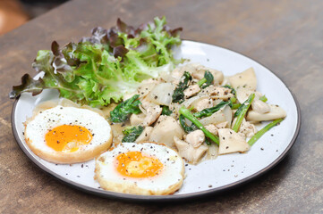 stir-fried chicken with mushroom and kale , sunny side up egg and lettuce