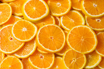 Top view of Orange slices against orange background.