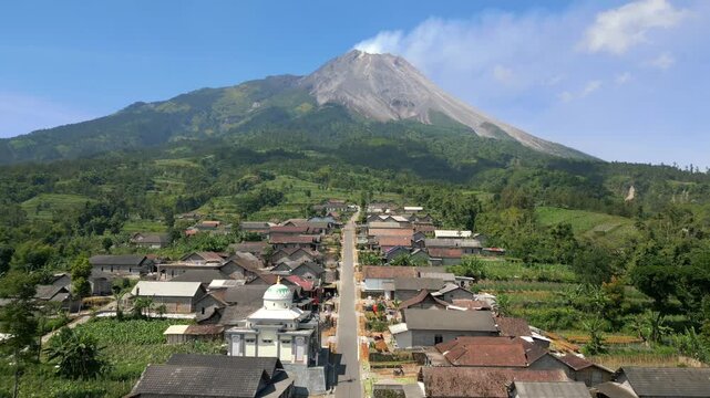 Aerial view of the active Merapi volcano and picturesque village on its slope in Indonesia