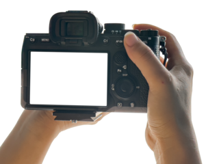 Hand holding Mirrorless camera with white screen isolated on transparent background. PNG File