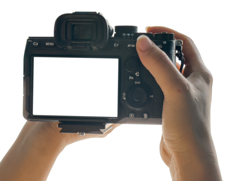 Hand holding Mirrorless camera with white screen isolated on transparent background. PNG File