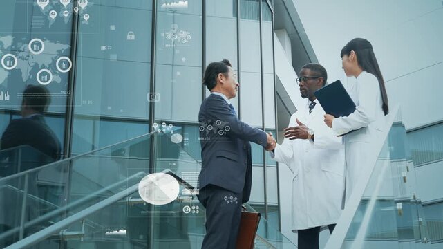 握手するビジネスパーソンと外国人科学者のグループとビジネスデータ