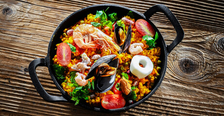 Seafood paella served in a cast iron pan