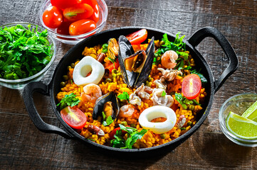 Seafood paella served in a cast iron pan