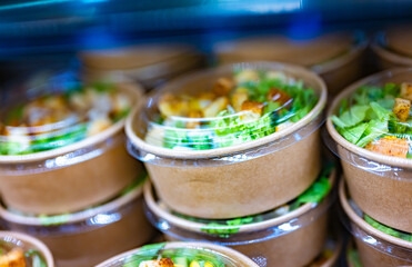 Vegetable salads displayed in a commercial refriger