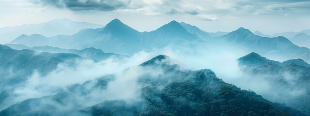  A bird's-eye perspective of a fog-shrouded mountain range with clouds hugging the foreground