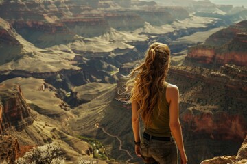 Woman standing on the edge of Grand Canyon.