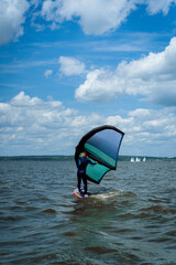 Wing foil rider riding in the lake.