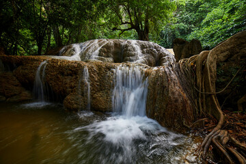 Naklejka premium Scenic view of waterfall in forest