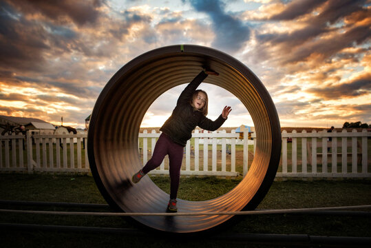 Young girl playing at park at sunset