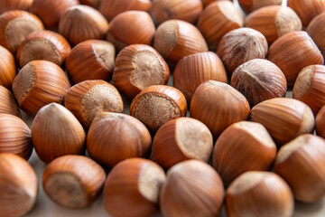 natural hazelnuts on white surface - close macro photo