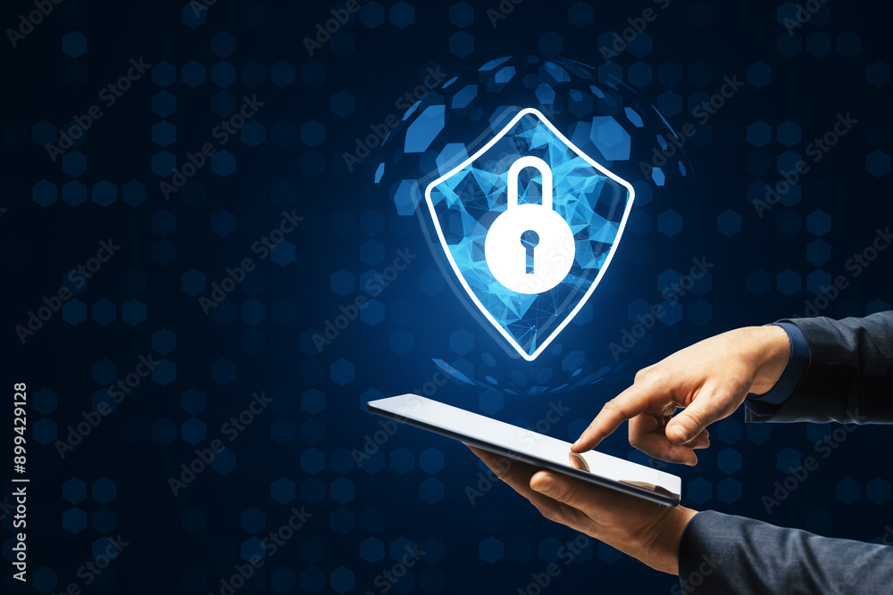 Aufkleber Hands using a tablet with a cybersecurity lock icon on a digital background.