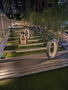 Capture the enchanting beauty of a landmark building illuminated at night, surrounded by a serene park. Perfect for showcasing urban elegance and nature's tranquility