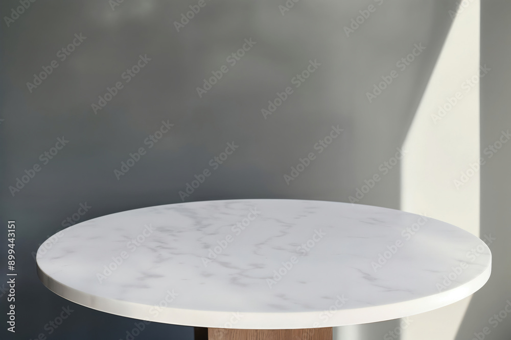 Poster round white empty marble table top on gray wall background with sunlight, displaying your product