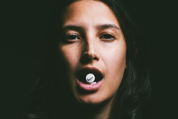 Studio, depression and portrait of woman with tablet for mental health, medication and treatment. Face, drug and person with happy pill for antidepressant, psychiatric and support on black background