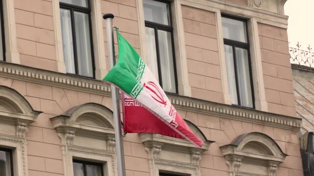 The Iran national flag waving. The Islamic Republic of Iran is a State of Asia located on the Middle East. Slow motion 