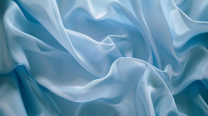 Soft, light blue fabric captured in unwinding, delicate folds, showcasing texture and gentle movement against a serene backdrop.