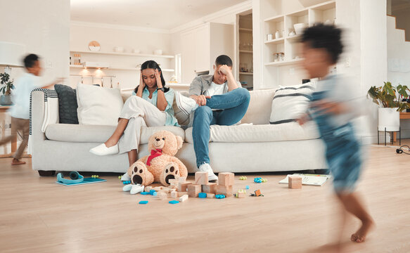 Parents, children and chaos house or running in living room, ADHD kids and hyper active on weekend break. Frustrated people, sofa and stress for noise and motion blur, movement and energy for burnout
