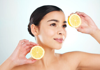Beauty, woman and lemon for skincare in studio with vitamin c, acne scarring and digestion. Model,...