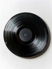 Fototapeta premium A black record is sitting on a white wall