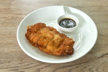 Tonkatsu crispy fried pork with flour dipping swwt soy sauce on plate