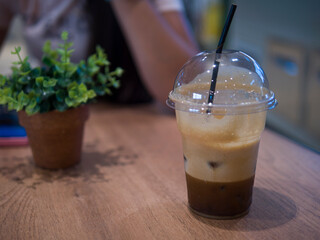 On table, a plastic cup with Cold Brew Coffee gleams, ready to refresh. Cold Brew Coffee in clear plastic cup captures the essence of a cool, delightful drink, making Cold Brew Coffee irresistible.