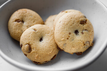 American Twix soft cookies with chocolate and caramel drops in white bowl
